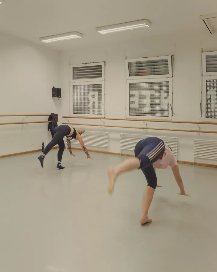 Students kicking up into handstands, each in their own way